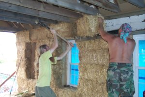 Aaron knocks a bale into place