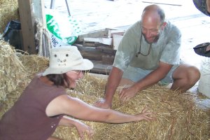 Kurt and Laurel retie a bale